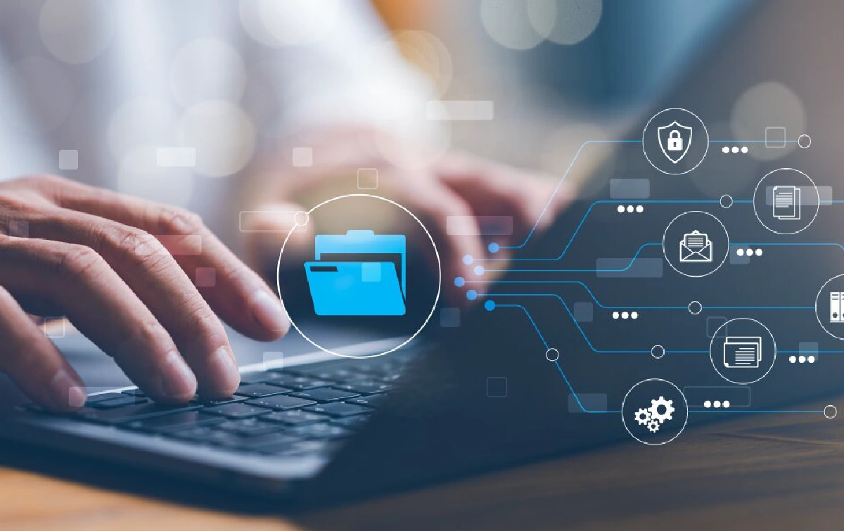 Close-up of a man’s fingers typing on a laptop